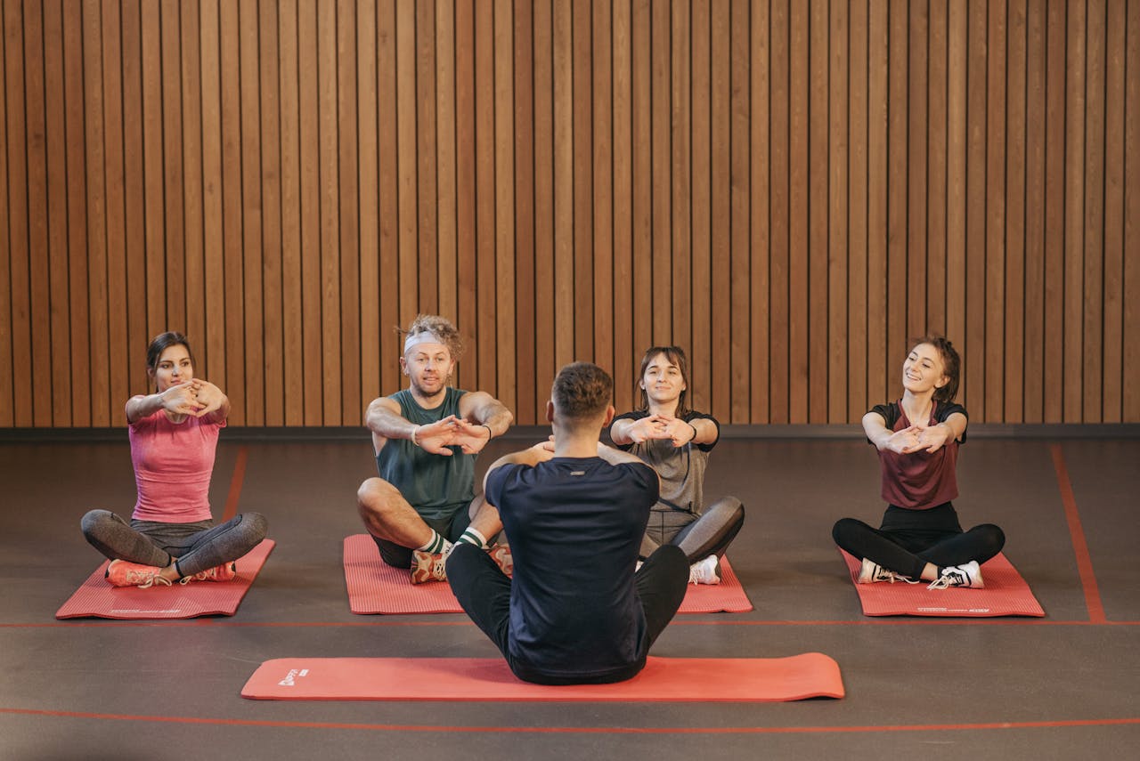 menu-16 A diverse group practicing yoga in a studio with a focus on wellness and mindfulness.